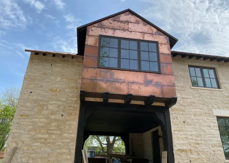 Copper metal panel facade on a stone building for Metal Roof Coating in Endicott